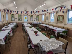 Festive decorated hall at Baumber Village Hall with Union Jack themed tableware and bunting for community events.